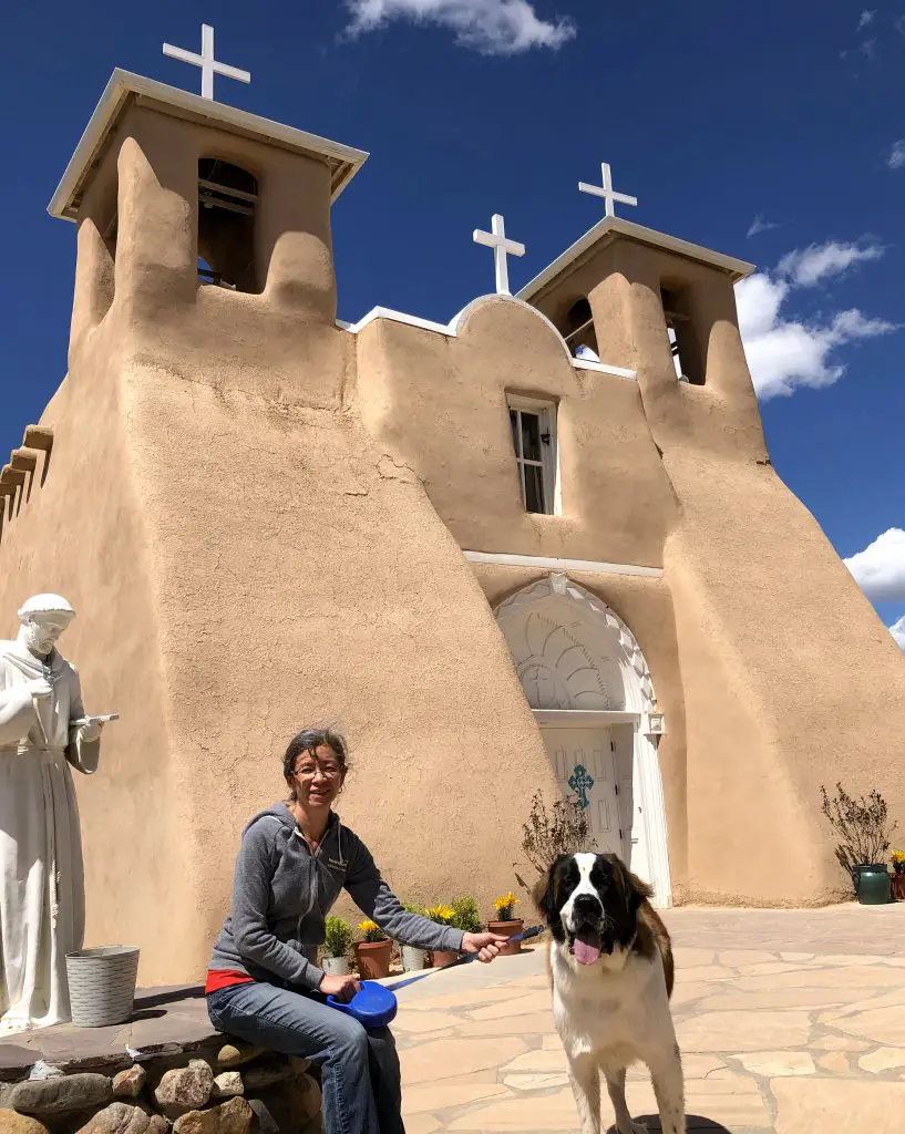 San Franciso De Asis Church with dog and person in foreground