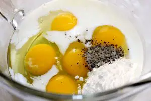 eggs, milk, flour, salt, and pepper in a mixing bowl