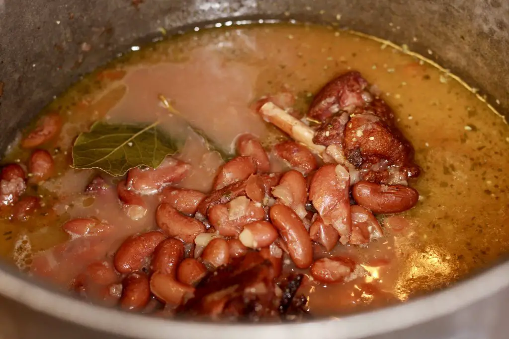 Beans ham hock and bay leaf in a pot