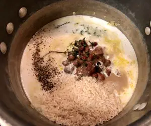 rice, beans, coconut milk, thyme, chicken broth and seasonings in a saucepan