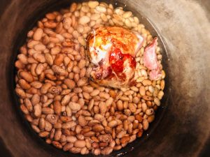Pinto beans and pork hock in a pan