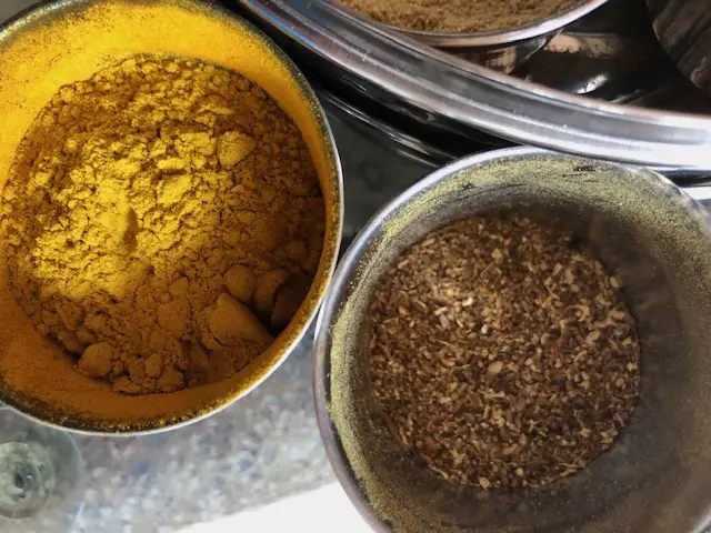 overhead shot of turmeric and garam masala in spice pots
