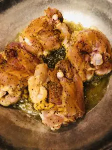 browning seasoned chicken in a skillet