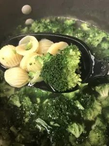 broccoli and orecchiette on a ladle