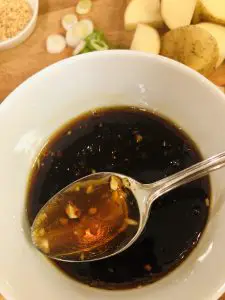 braising sauce in a bowl with a spoon