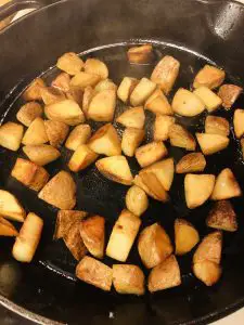 bite sized potatoes frying in a pan