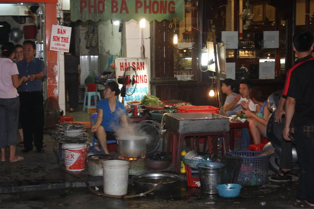 Vietnamese people eating pho