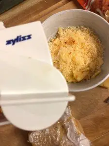 Zyliss cheese grater and shredded Edam cheese in a bowl