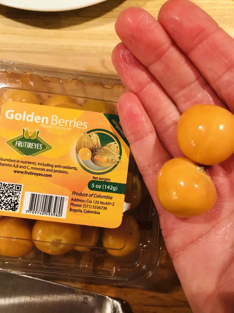 Golden Berries in a package and on a human hand