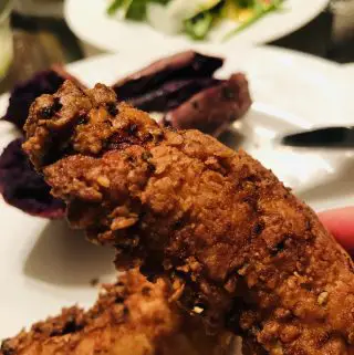 Spicy Chicken Tenders with purple potato in the background