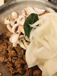 Italian Sausage, sliced mushrooms, sliced onions, and bay leaf