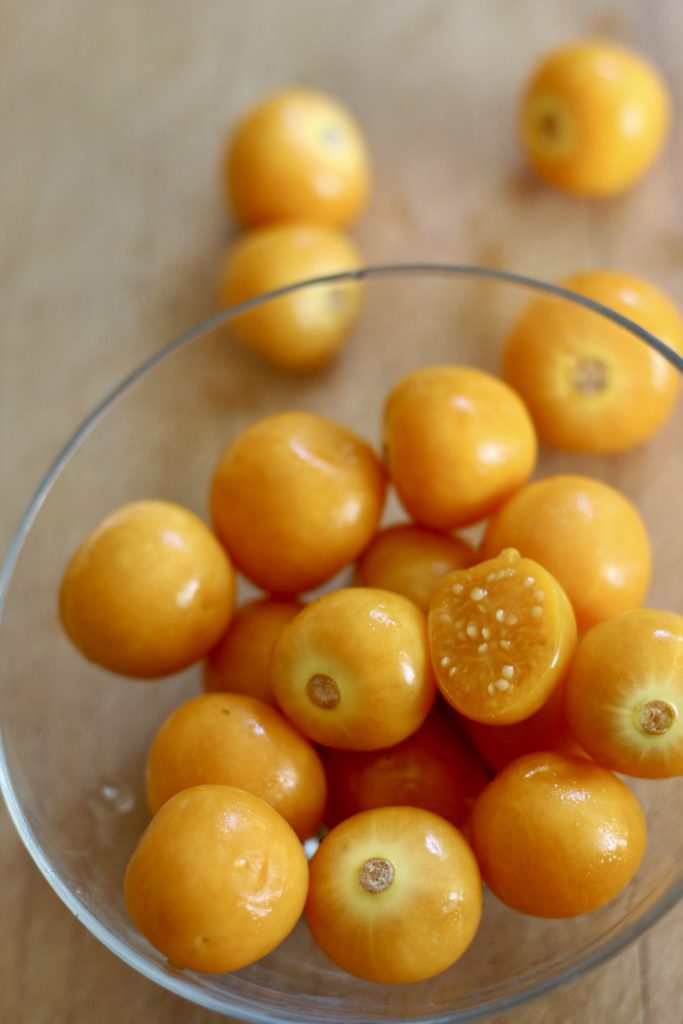 Cape Gooseberry in a glass bowl with a few scattered around