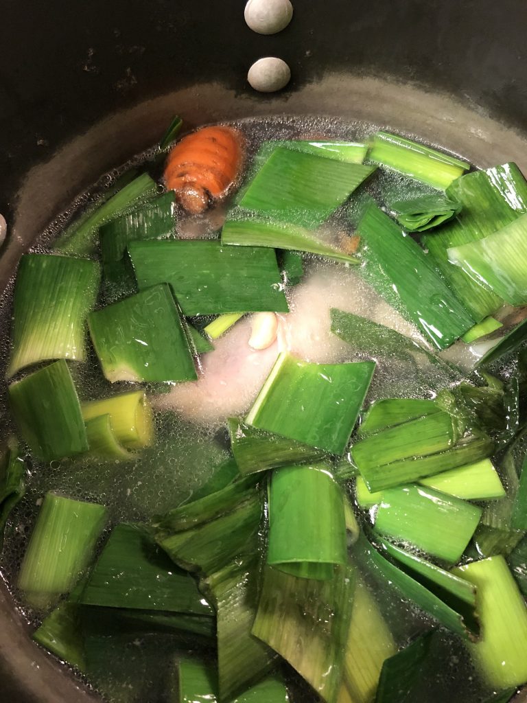 Chicken, leeks, carrot, onion and bay leaf in a large stock pot filled with water