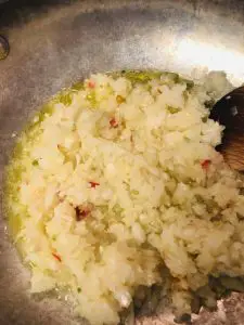 minced onion, garlic, ginger, and chilis in olive oil in a pan