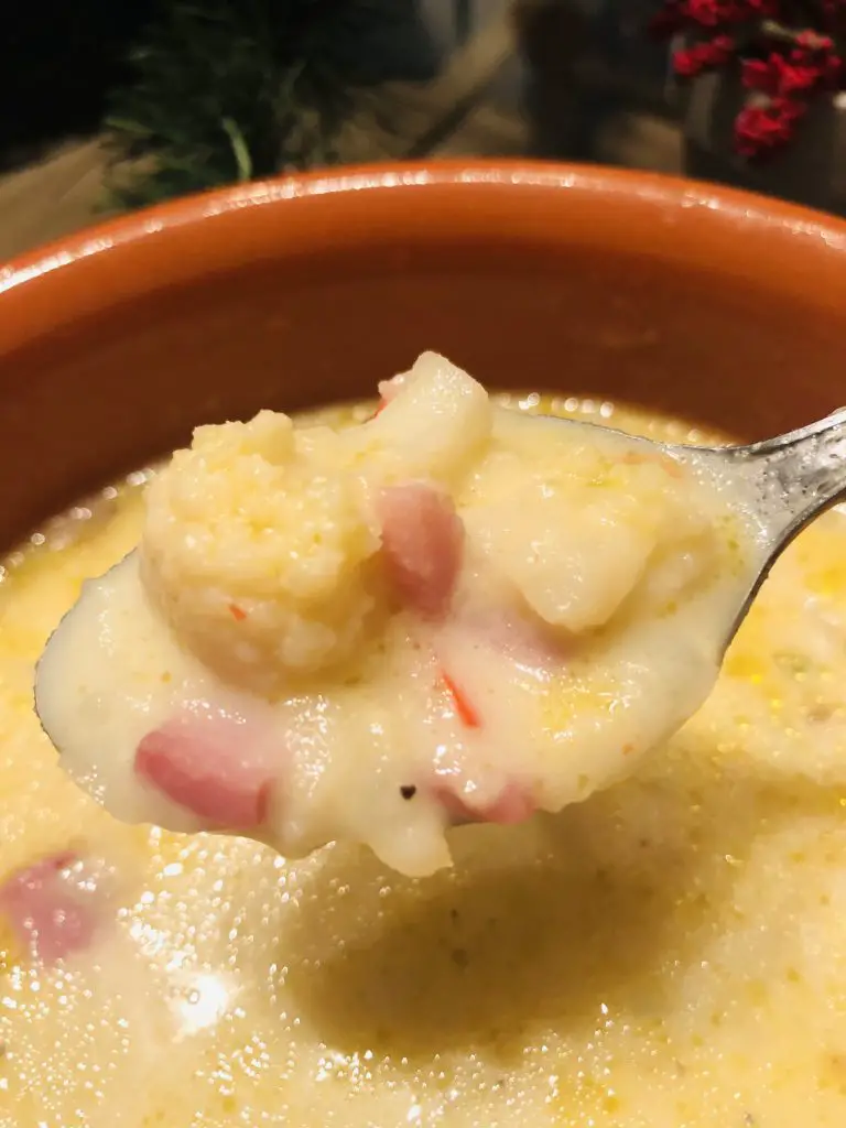 Creamy Cauliflower, Potato, and Cheesy Ham Chowder in a spoon
