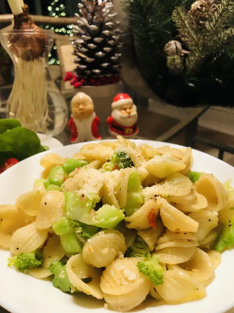 Orecchiette With Broccoli in a white bowl with santa and mrs klaus