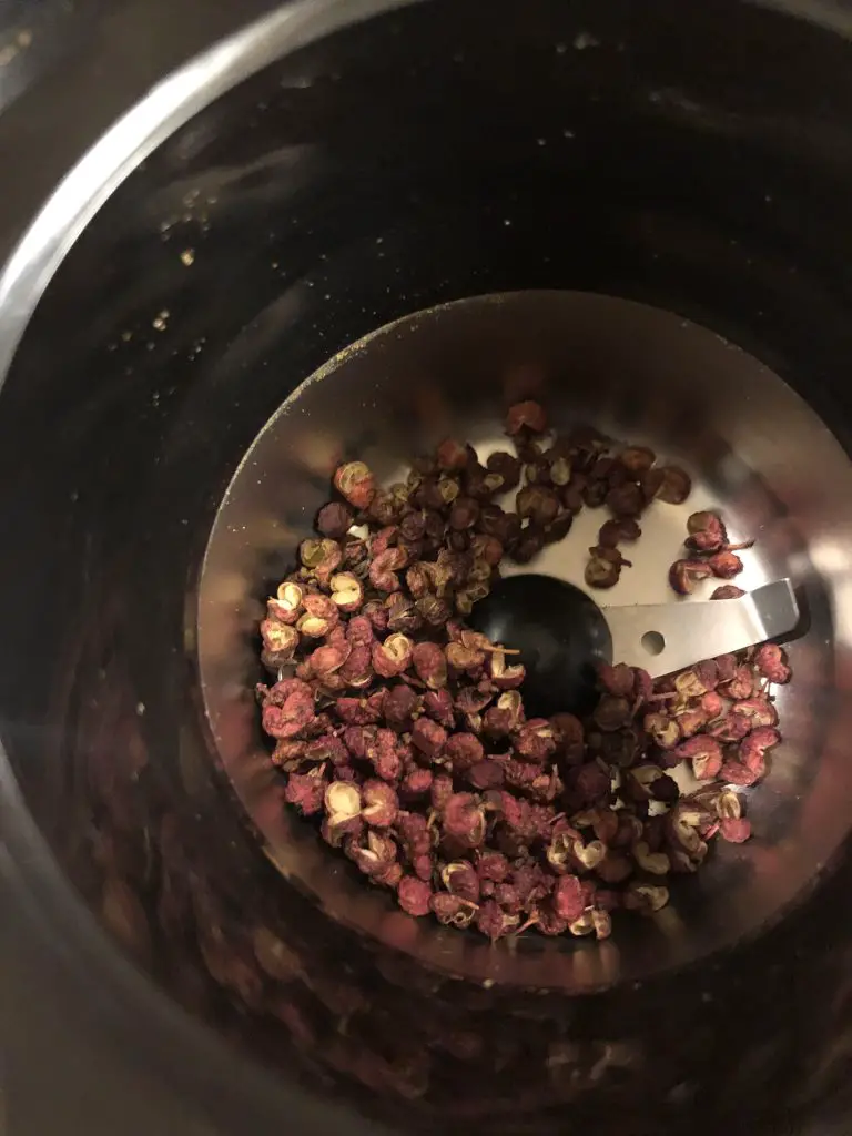 Sichuan peppercorns in a coffee grinder