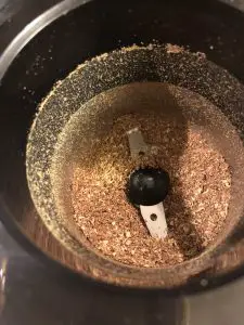 Ground Sichuan peppercorns in a coffee grinder