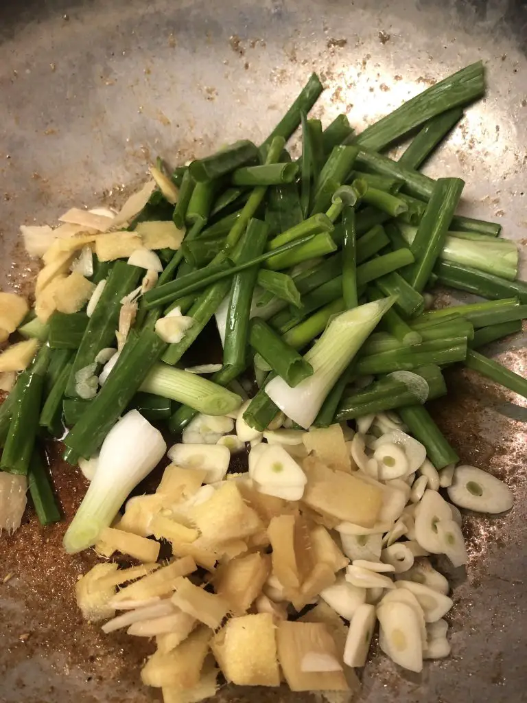 ginger, garlic, and scallions in a large skillet 