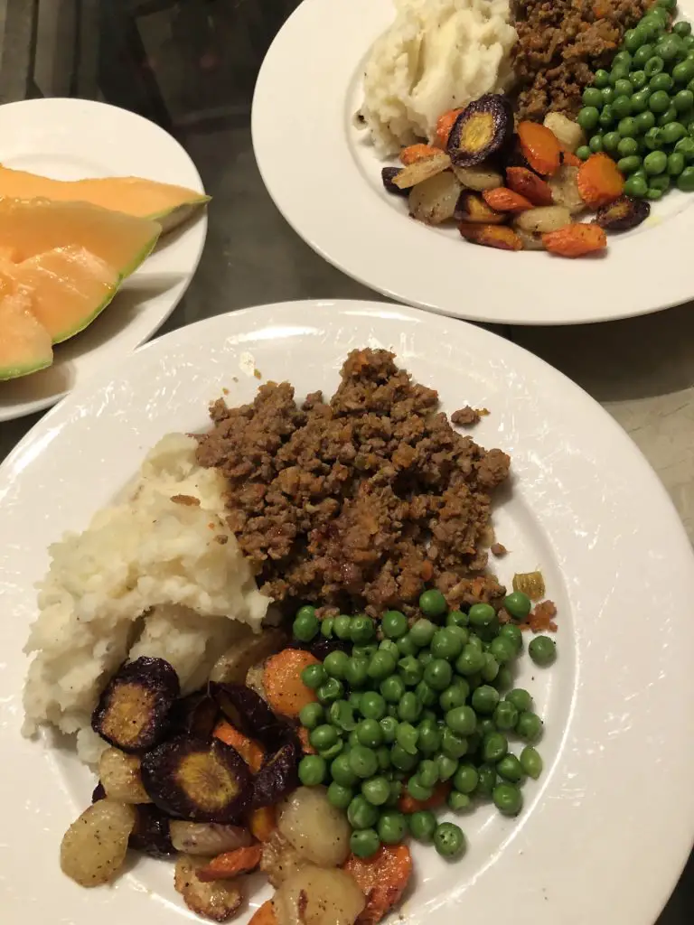 MInce and Tatties served with peas and carrots with cantaloupe on the side