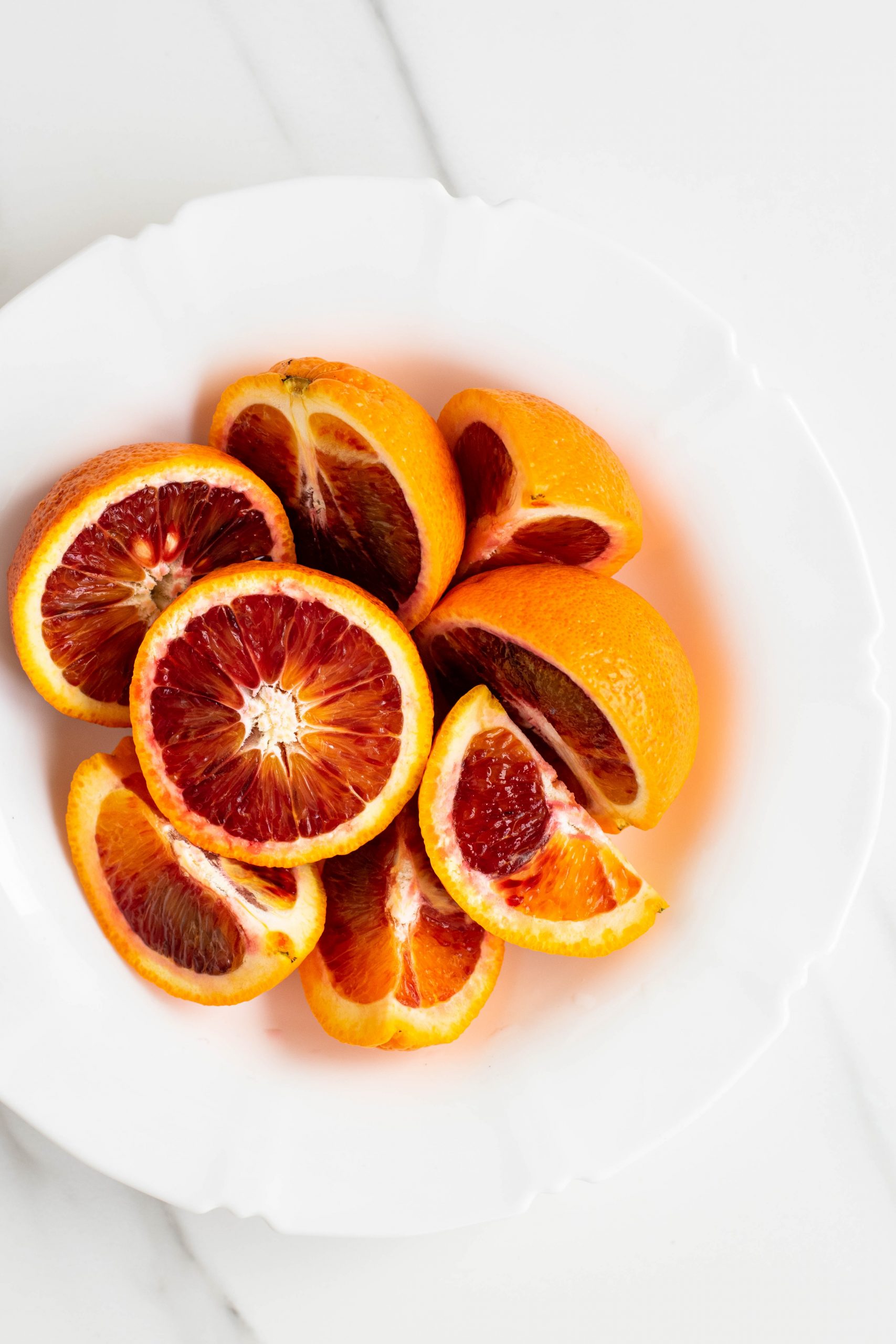 Blood oranges on a white plate
