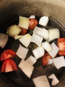onions, tomatoes and water in a saucepan