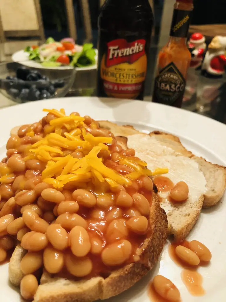 Beans on Toast with Worcestershire and Tabasco sauces and a salad in the background