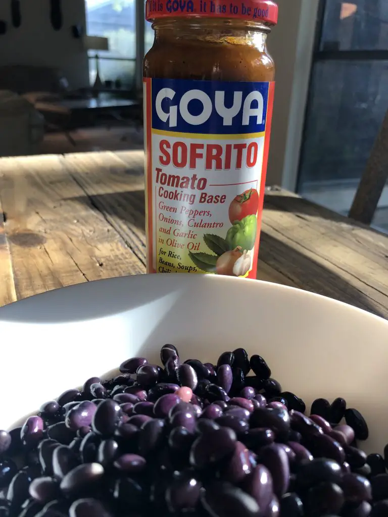 Black beans in a white bowl and Goya Sofrito 