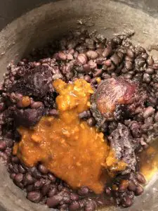 Cooked black beans and ham hock with sofrito