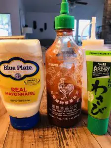 Bottles of mayo, sriracha, and wasabi