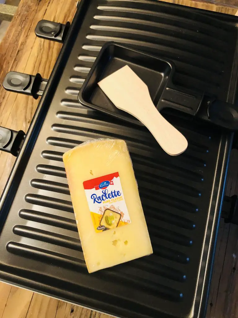 Raclette cheese, raclette grill, and scraper