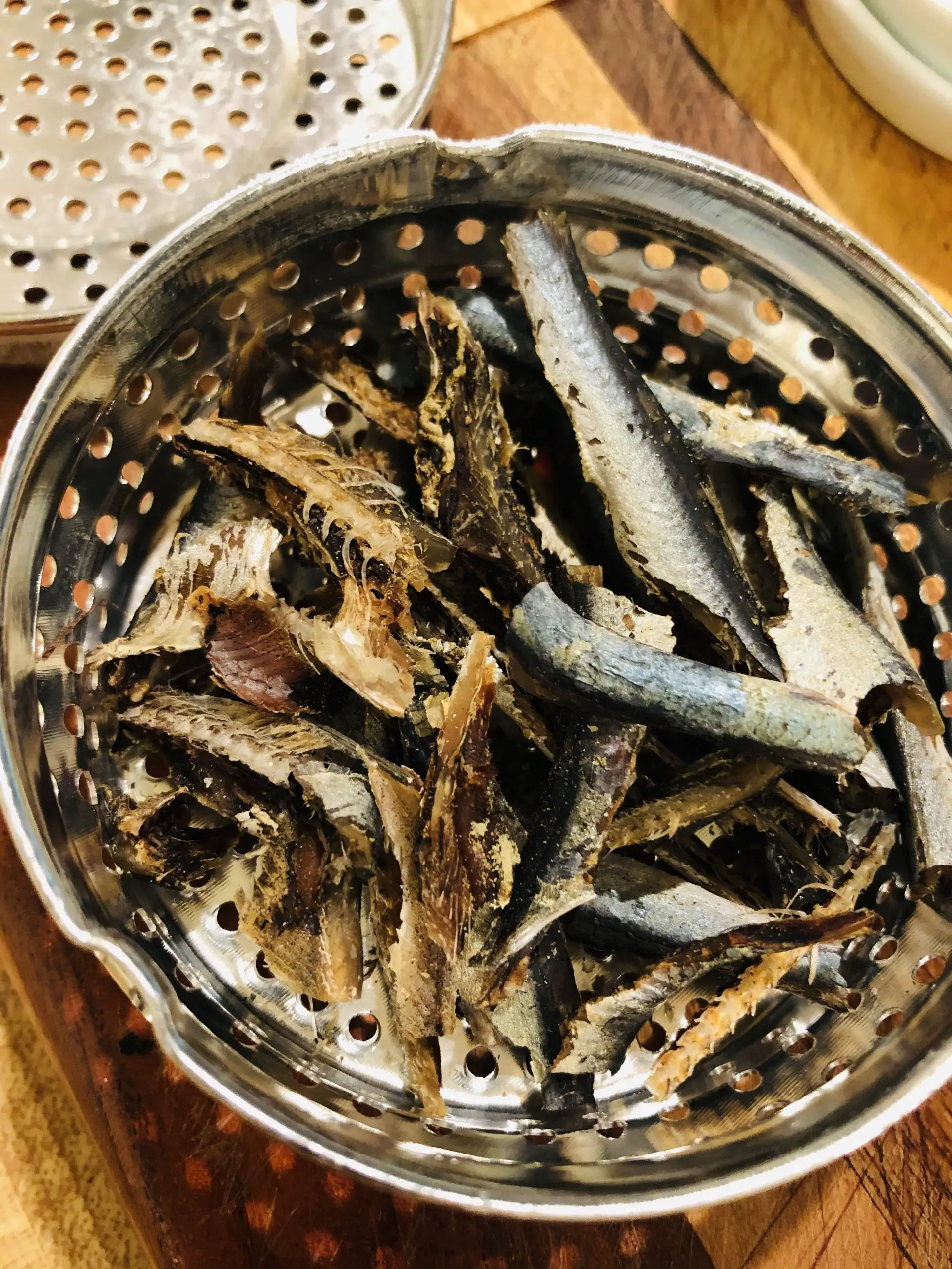 Anchovies in an anchovy strainer