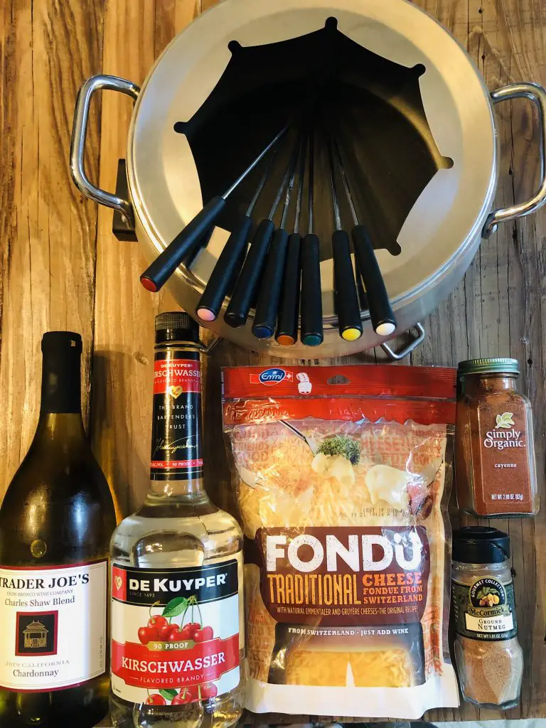 Trader Joe's Chardonnay, Kirschwasser, emmin fondue cheese, Cuisinart electric fondue maker and forks, nutmeg, and cayenne pepper
