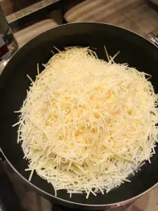 grated cheese in a fondue pot