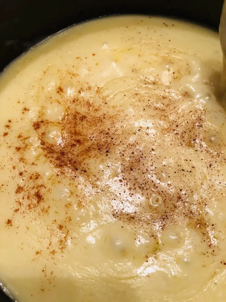 melted cheese with cayenne and nutmeg in a fondue pot