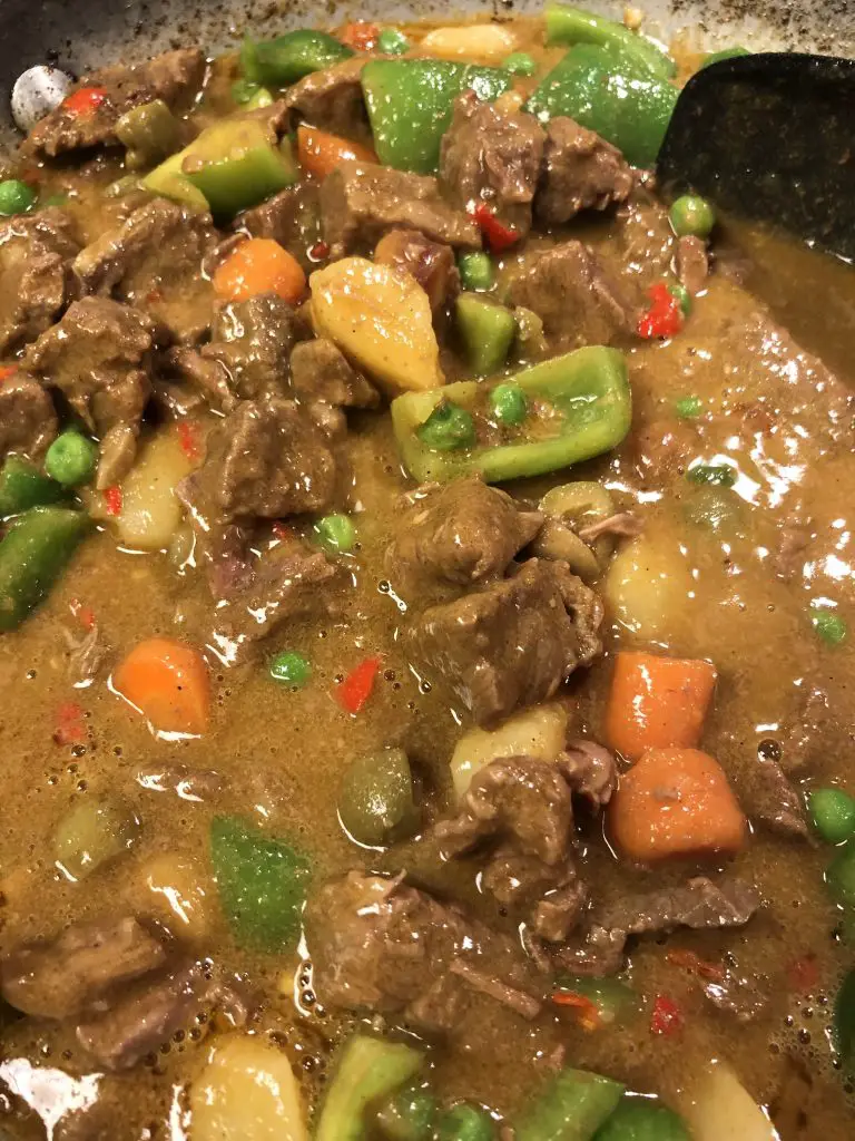 Beef caldereta with peas, green bell pepper, carrots, and potatoes
