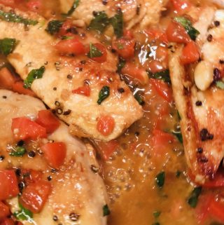 Chicken with basil, chopped tomato, and butter sauce