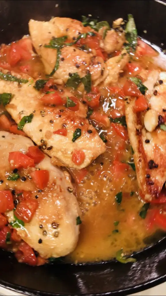 Chicken with basil, chopped tomato, and butter sauce
