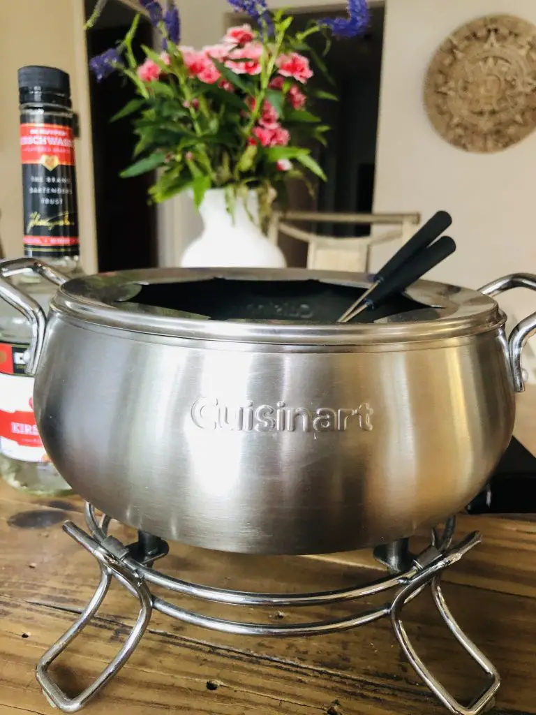 Cuisinart Electric Fondue Maker with fondue forks and flowers in the background