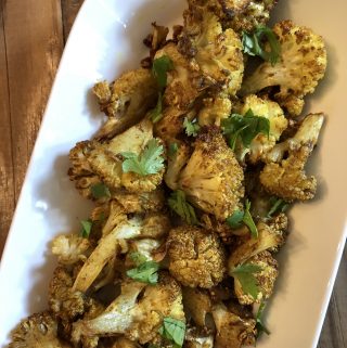 Indian Spiced Cauliflower in a white serving dish