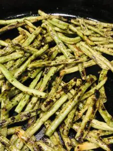 Chinese Long Beans cut into small pieces and cooked until charred in a cast iron pan