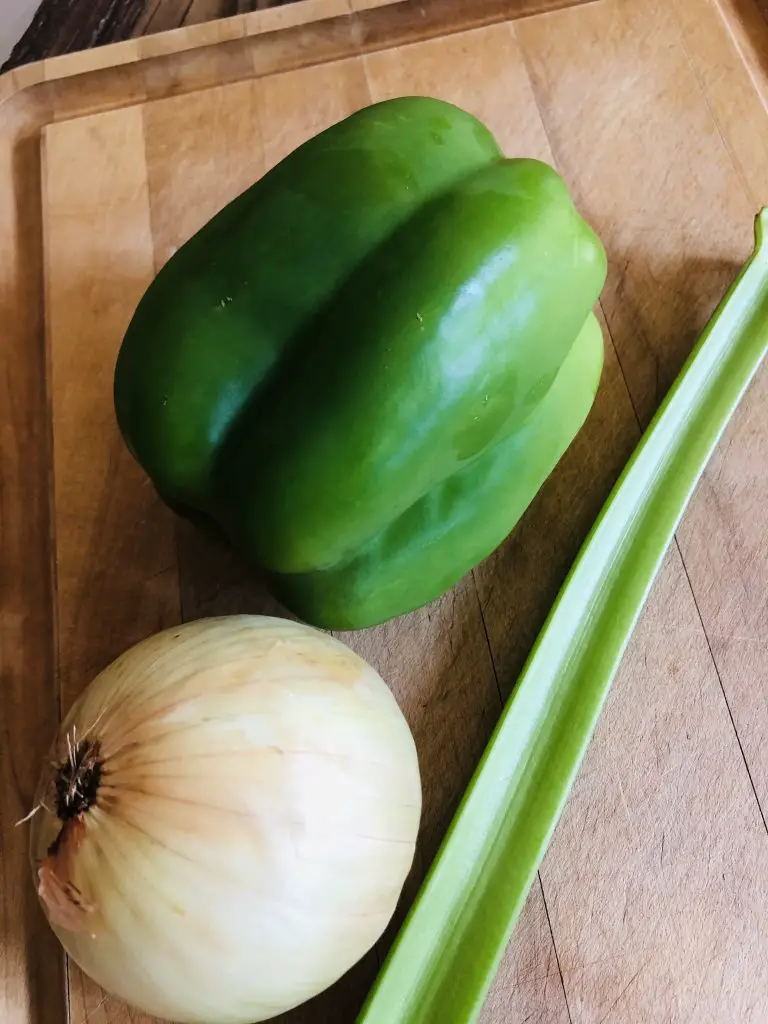 green bell pepper, onion, and celery on a wooden board