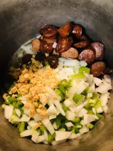 sausage, minced garlic, diced onion, green bell pepper and celery in a large stock pot