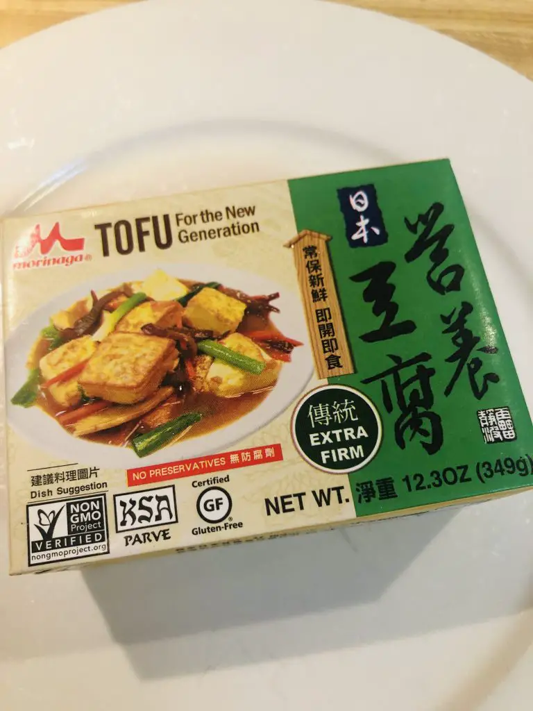 A box of morinaga extra firm tofu on a white plate