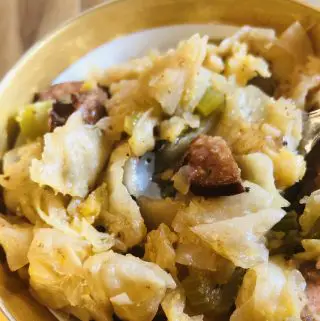Cajun Smothered Cabbage in a gold rimmed bowl
