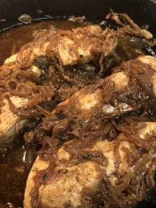 Chicken with caramelized onion in a cast iron skillet