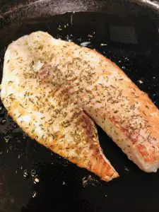 Browned and Cooked Tilapia With Za'atar in a cast iron pan