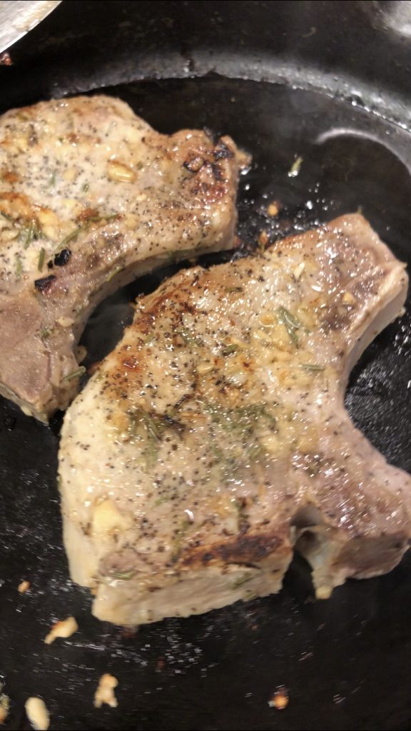 sous vide pork chops in a cast iron pan