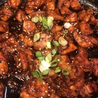 Spicy Chicken Bulgogi garnished with green onions and sesame seeds