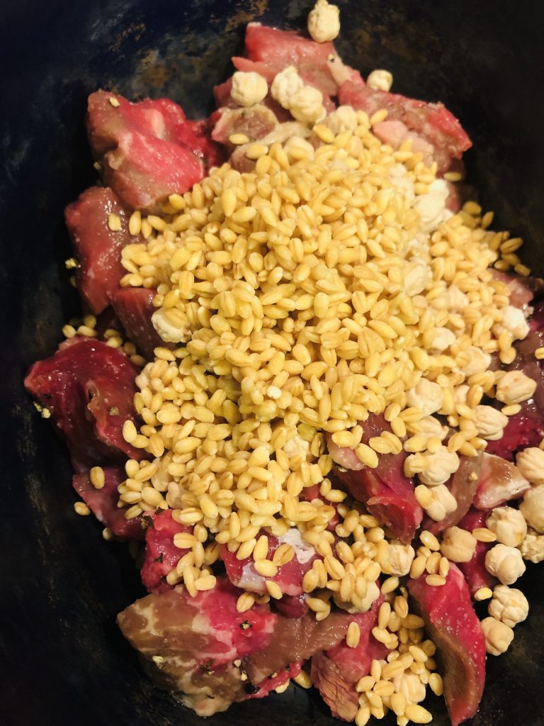 beef stew meat with barley and chickpeas on top